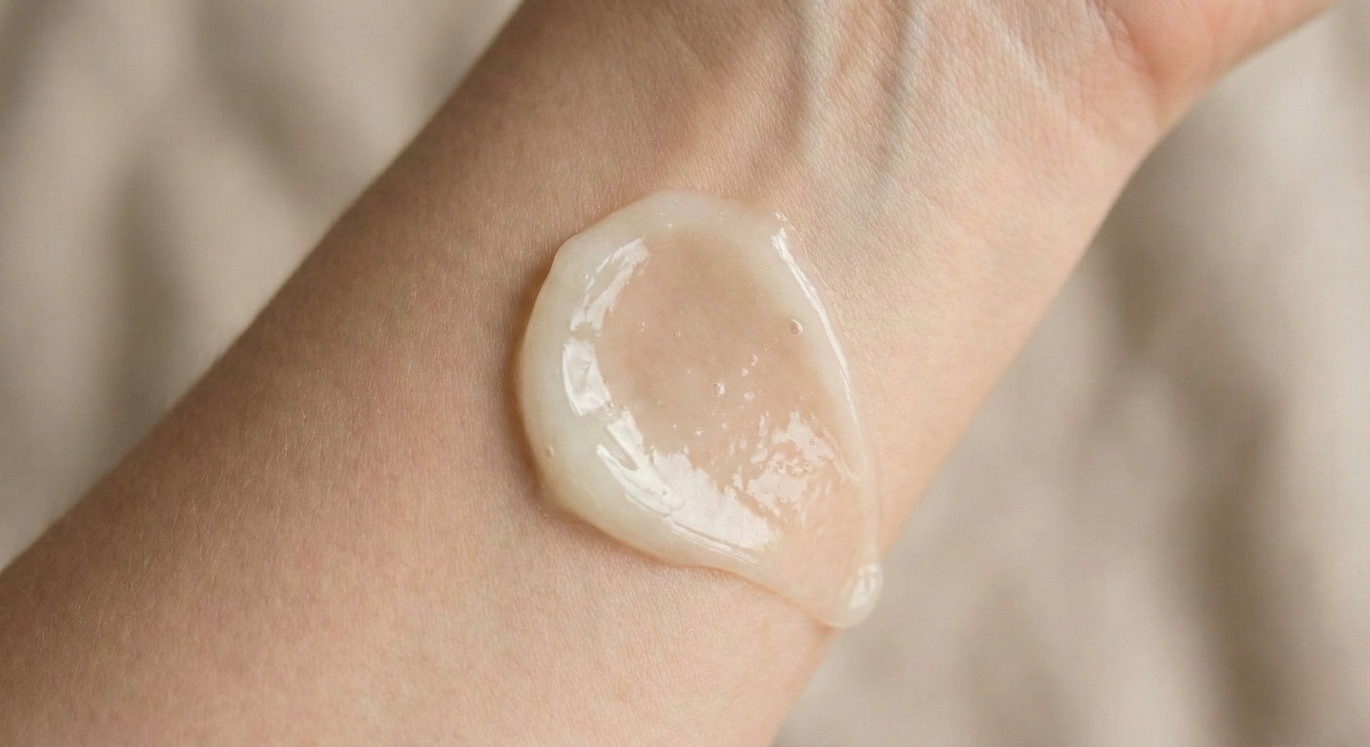 Close up image of a thick essential oil texture on skin, representing heavier oils that may not absorb easily into the scalp.